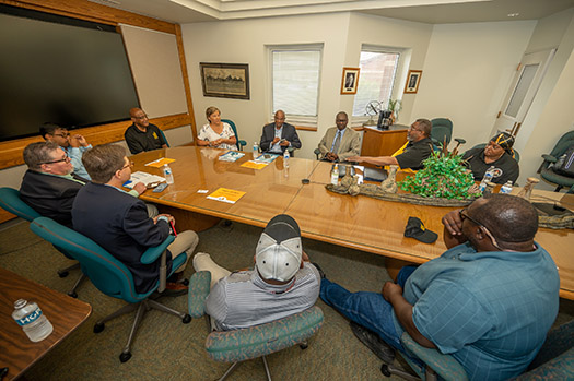 People sitting in a conference room around a large table