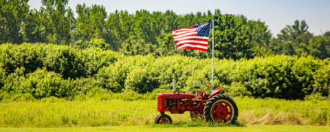 Red tractor with U.S. flag.